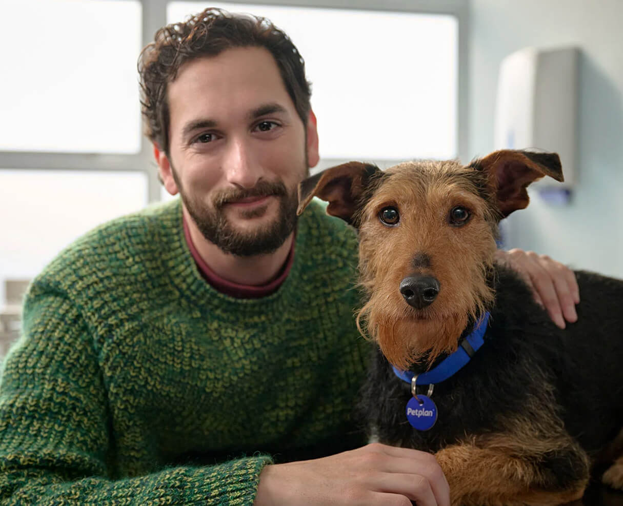 a man with a brown dog