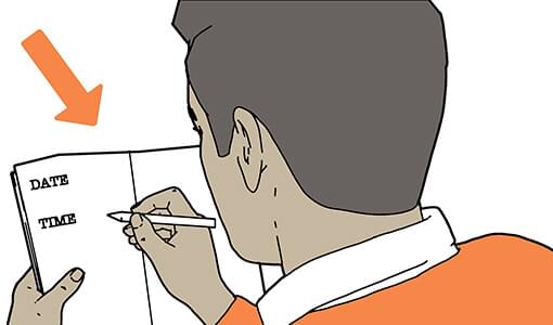 A man writing in a diary, with date & time written down.