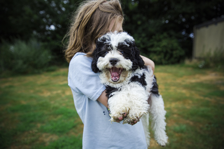 girl cuddling dog