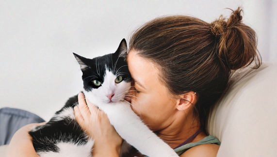woman hugging cat