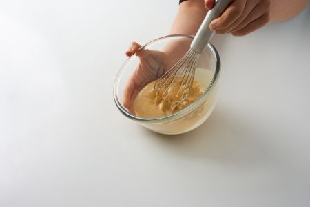 Whisking ingredients into a batter.