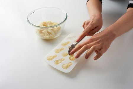 Snowman bites paste being placed into molds.