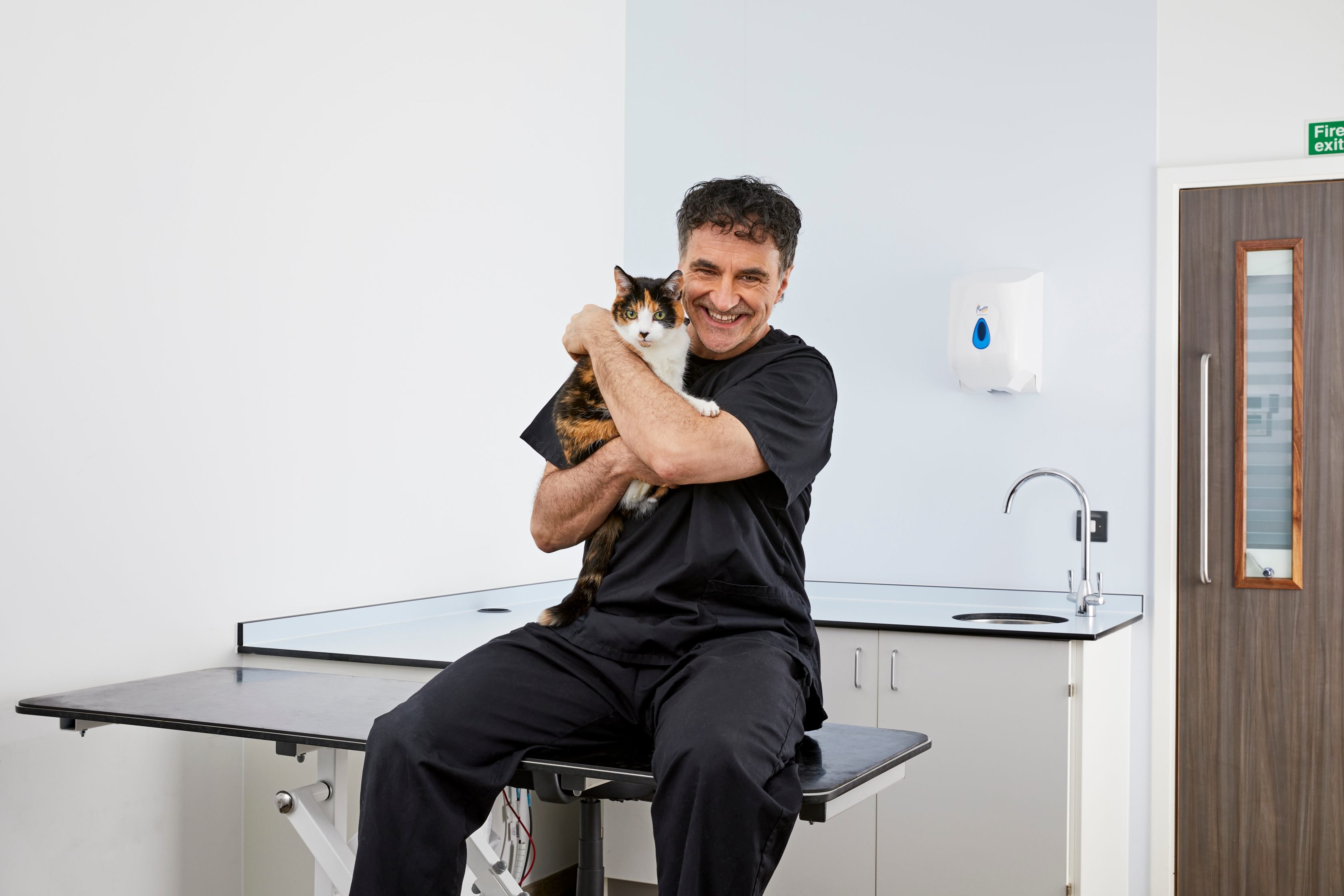 Veterinarian Noel Fitzpatrick holding a cat at the vets.