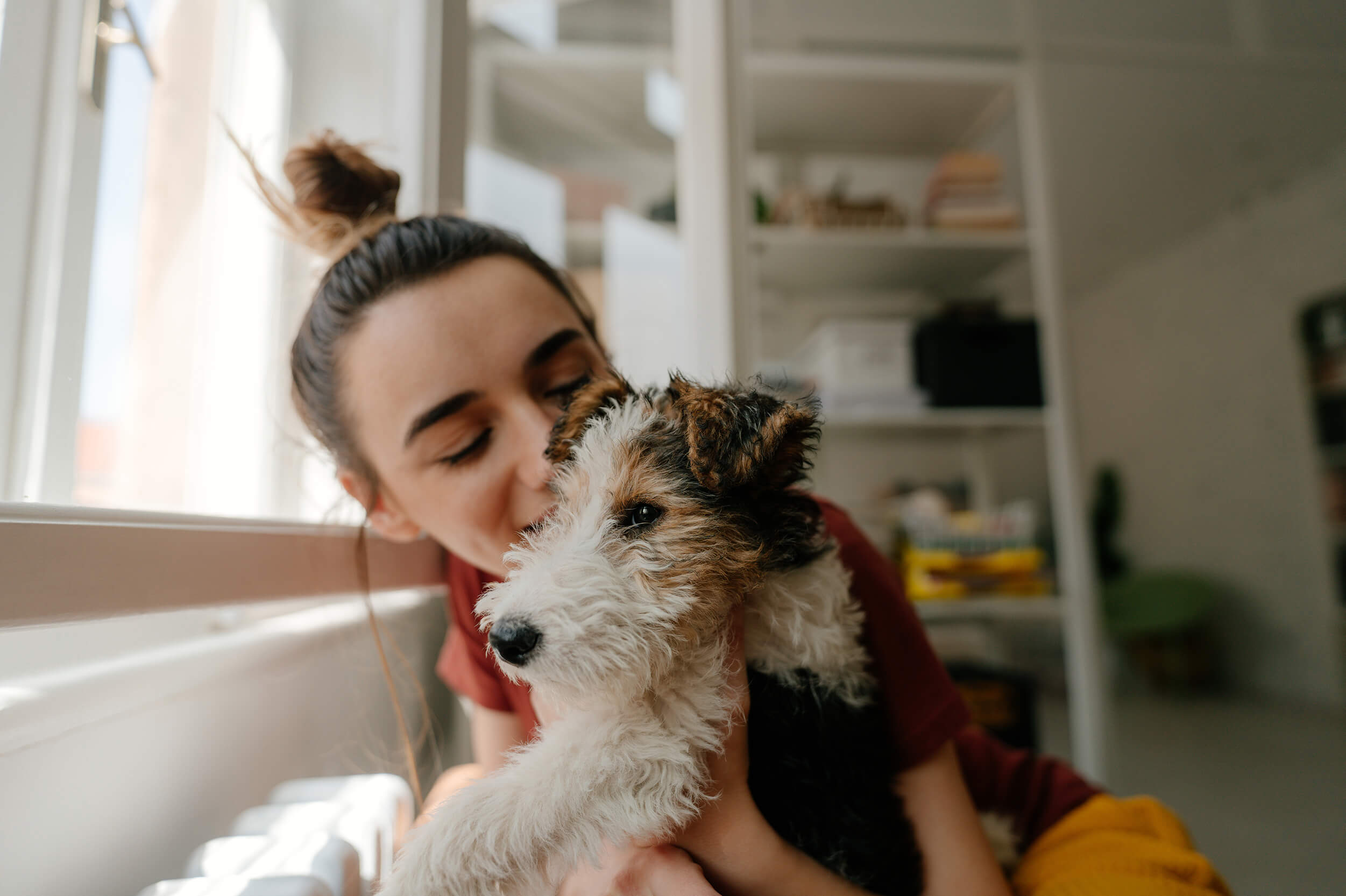 Woman and dog by window 